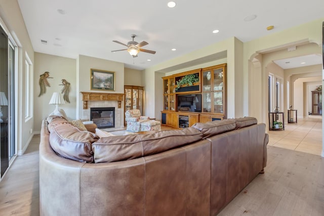 4638 W Lark Ct, Visalia, CA 93291 - living area featuring a tile fireplace, ceiling fan, light wood-style floors, and recessed lighting
