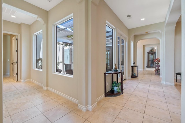 4638 W Lark Ct, Visalia, CA 93291 - hallway with light tile patterned floors and arched walkways
