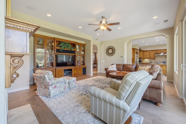 4638 W Lark Ct, Visalia, CA 93291 - living area featuring ceiling fan, arched walkways, light wood-type flooring, and recessed lighting