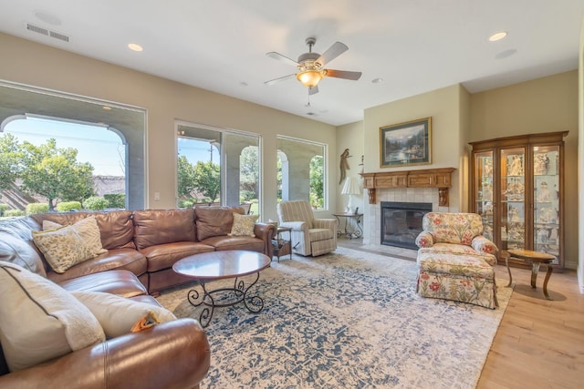 4638 W Lark Ct, Visalia, CA 93291 - living area with a ceiling fan, a tiled fireplace, light wood finished floors, and recessed lighting