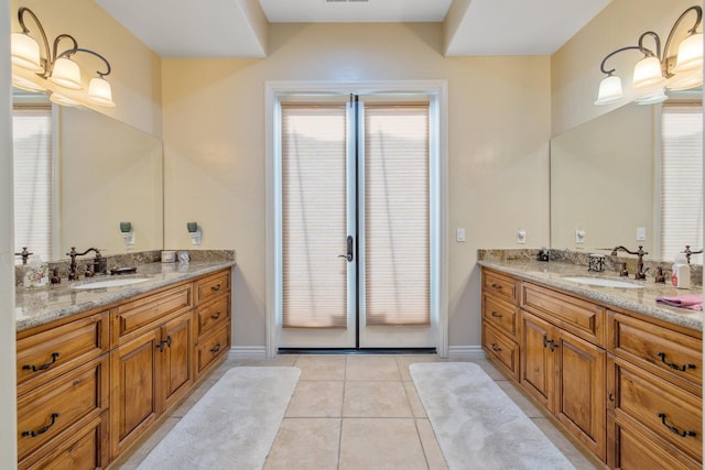 4638 W Lark Ct, Visalia, CA 93291 - full bath with two vanities, tile patterned floors, and plenty of natural light