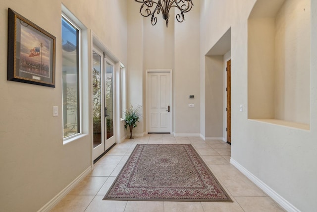 4638 W Lark Ct, Visalia, CA 93291 - foyer entrance with light tile patterned floors, a chandelier, and a high ceiling