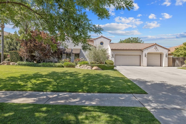 4638 W Lark Ct, Visalia, CA 93291 - mediterranean / spanish home with an attached garage, stucco siding, concrete driveway, and a front yard