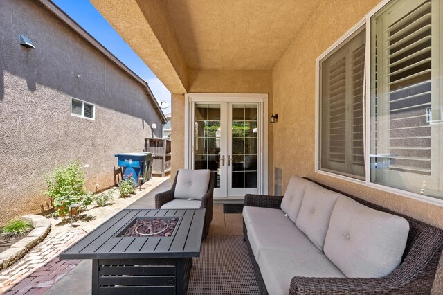5313 W King Fisher Ln, Fresno, CA 93722 - view of patio / terrace featuring french doors and an outdoor living space with a fire pit