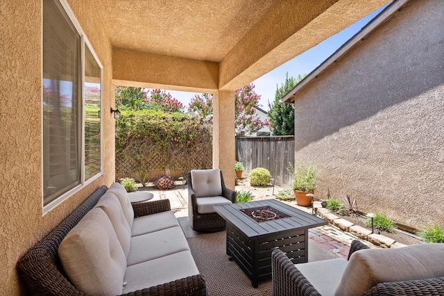 5313 W King Fisher Ln, Fresno, CA 93722 - view of patio with an outdoor living space with a fire pit