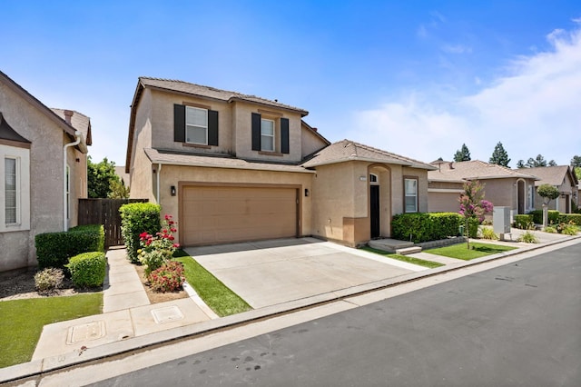 5313 W King Fisher Ln, Fresno, CA 93722 - traditional-style home featuring stucco siding, concrete driveway, and an attached garage
