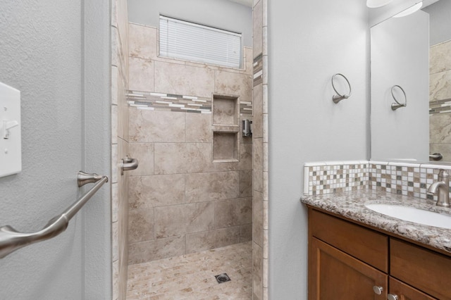 5313 W King Fisher Ln, Fresno, CA 93722 - full bathroom featuring vanity, tiled shower, and decorative backsplash