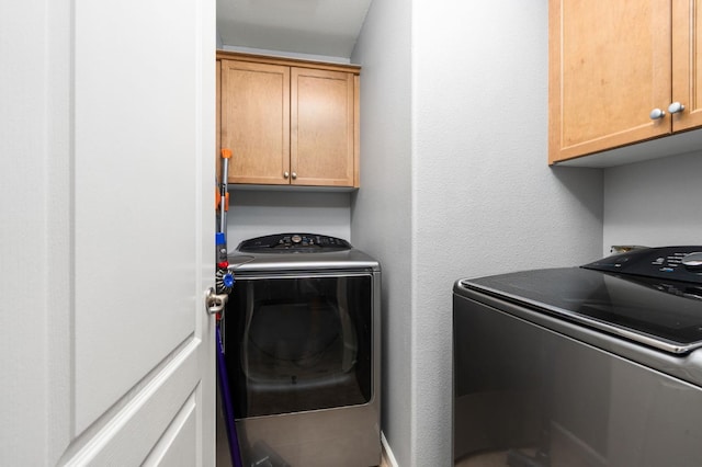 5313 W King Fisher Ln, Fresno, CA 93722 - laundry room with cabinet space and separate washer and dryer