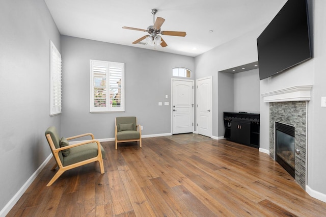 5313 W King Fisher Ln, Fresno, CA 93722 - sitting room with a ceiling fan, hardwood / wood-style flooring, and a fireplace