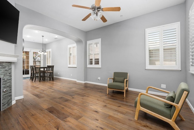 5313 W King Fisher Ln, Fresno, CA 93722 - sitting room with arched walkways, a ceiling fan, hardwood / wood-style flooring, recessed lighting, and a fireplace
