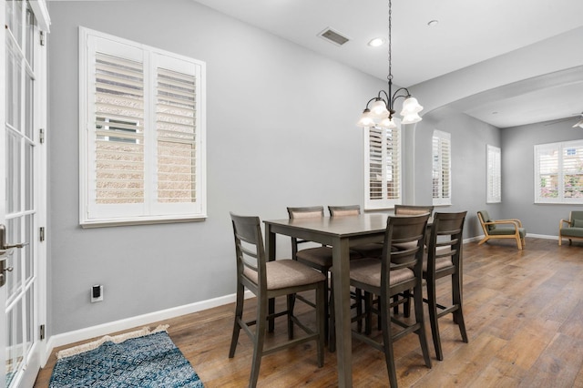 5313 W King Fisher Ln, Fresno, CA 93722 - dining space featuring wood finished floors, a chandelier, arched walkways, and recessed lighting