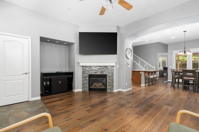 5313 W King Fisher Ln, Fresno, CA 93722 - living area with a ceiling fan, stairs, wood finished floors, and a fireplace