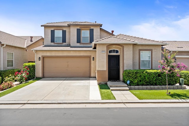 5313 W King Fisher Ln, Fresno, CA 93722 - view of front of home with stucco siding, driveway, a garage, a tiled roof, and a front yard