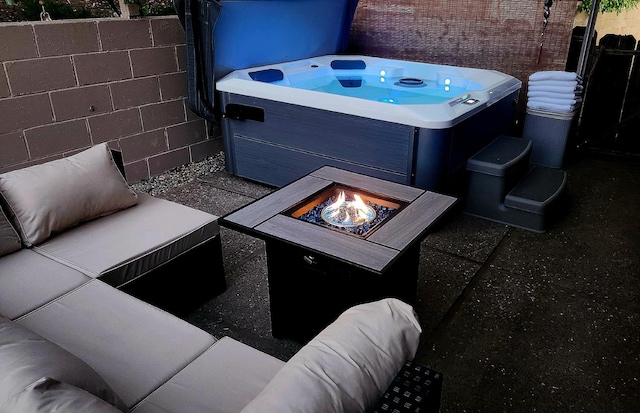 40885 Elliott Dr, Oakhurst, CA 93644 - view of patio / terrace with a hot tub and an outdoor living space with a fire pit