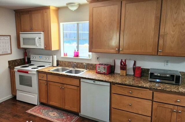 40885 Elliott Dr, Oakhurst, CA 93644 - kitchen featuring white appliances, dark wood-type flooring, stone counters, and brown cabinetry