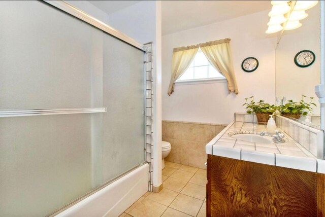 12420 S Chestnut Ave, Fresno, CA 93725 - bathroom featuring vanity, tile patterned flooring, shower / bath combination with glass door, a wainscoted wall, and a chandelier