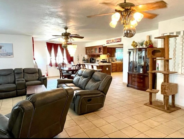 12420 S Chestnut Ave, Fresno, CA 93725 - living area featuring ceiling fan, plenty of natural light, and light tile patterned floors