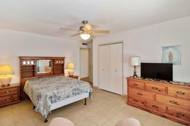 12420 S Chestnut Ave, Fresno, CA 93725 - bedroom with a closet, a ceiling fan, and light tile patterned floors