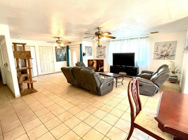 12420 S Chestnut Ave, Fresno, CA 93725 - living room with ceiling fan, light tile patterned floors, and a textured ceiling