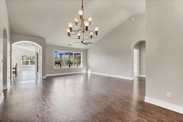 46453 Opah Dr, Ahwahnee, CA 93601 - unfurnished living room featuring arched walkways, a chandelier, dark wood finished floors, high vaulted ceiling, and a ceiling fan