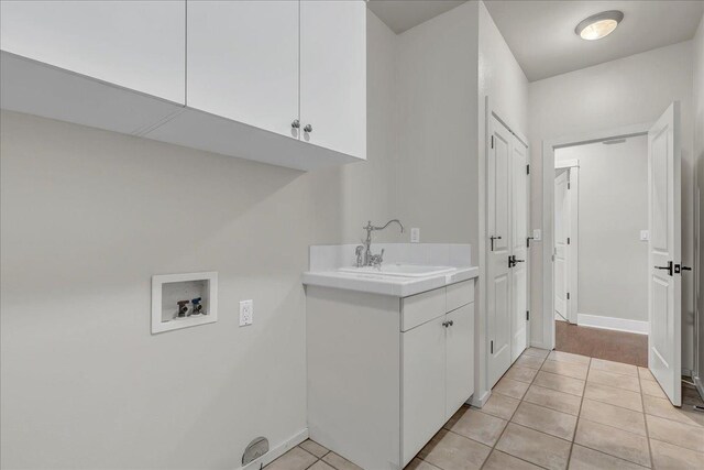 46453 Opah Dr, Ahwahnee, CA 93601 - laundry room featuring washer hookup, cabinet space, and light tile patterned floors