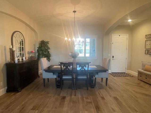 803 E Aretha Ave, Fowler, CA 93625 - dining room featuring arched walkways, a chandelier, and wood finished floors