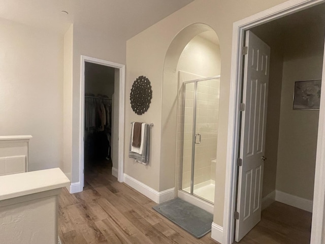 803 E Aretha Ave, Fowler, CA 93625 - full bathroom featuring wood finished floors, a stall shower, and a walk in closet