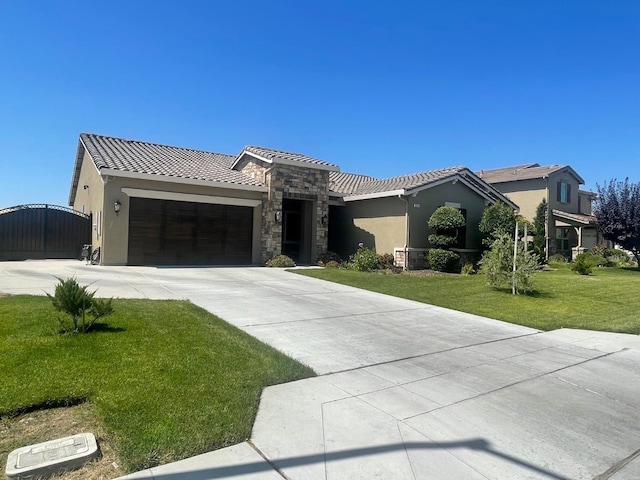 803 E Aretha Ave, Fowler, CA 93625 - single story home with stone siding, an attached garage, stucco siding, and a front yard