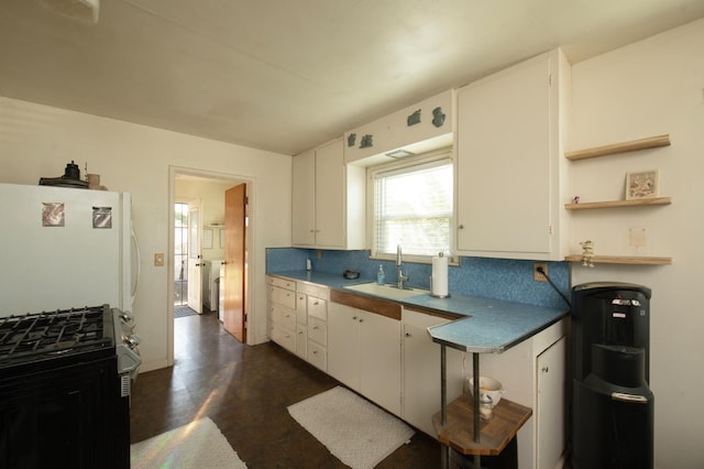 211 S 4th St, Fowler, CA 93625 - kitchen with stainless steel gas range oven, backsplash, freestanding refrigerator, and white cabinetry
