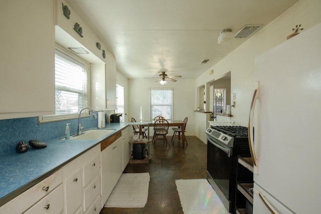 211 S 4th St, Fowler, CA 93625 - kitchen with freestanding refrigerator, stainless steel gas stove, white cabinets, a ceiling fan, and backsplash
