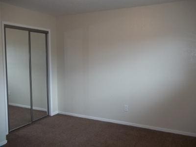 1139 W Alluvial Ave, Fresno, CA 93711 - unfurnished bedroom featuring a closet and dark colored carpet