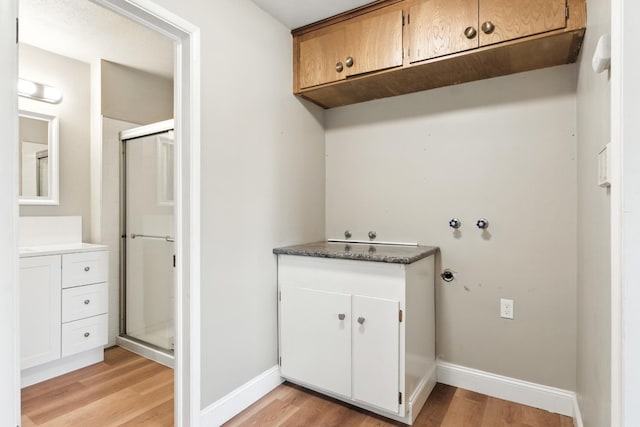 4558 E Weldon Ave, Fresno, CA 93703 - laundry area with cabinet space and light wood-style flooring