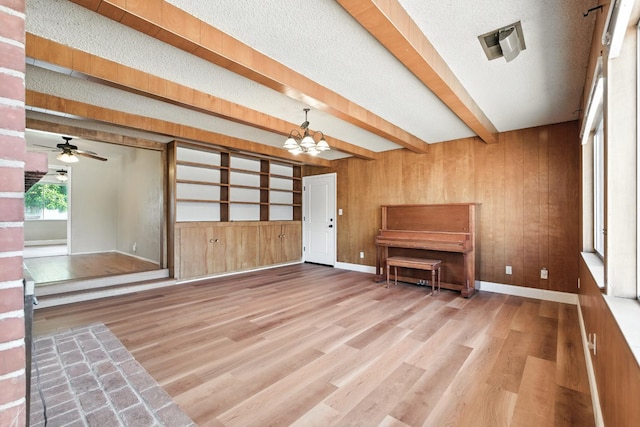 4558 E Weldon Ave, Fresno, CA 93703 - entrance foyer with wooden walls, wood finished floors, a chandelier, beamed ceiling, and a ceiling fan