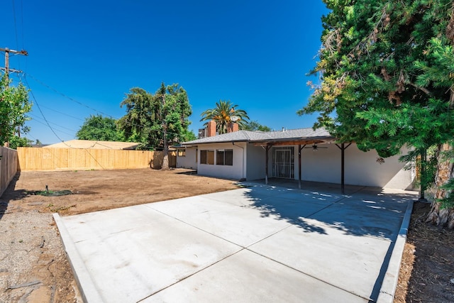4558 E Weldon Ave, Fresno, CA 93703 - rear view of house with a fenced backyard, ceiling fan, stucco siding, and a patio area
