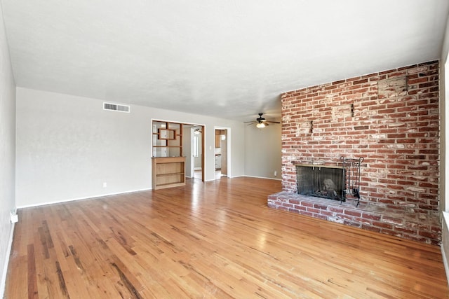 4558 E Weldon Ave, Fresno, CA 93703 - unfurnished living room with a ceiling fan, a fireplace, and wood finished floors