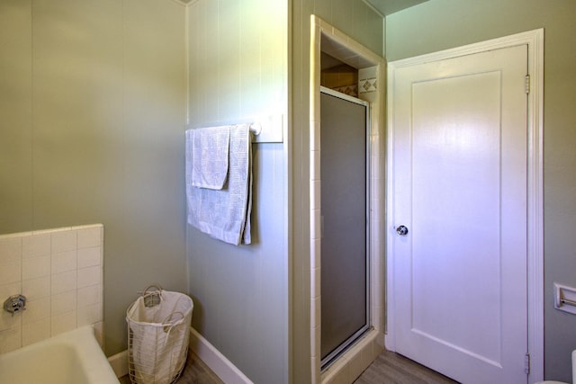 3364 E Princeton Ave, Fresno, CA 93703 - bathroom with a shower stall, a garden tub, and wood finished floors