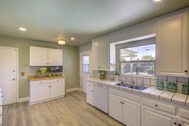 3364 E Princeton Ave, Fresno, CA 93703 - kitchen with white dishwasher, white cabinets, tile counters, decorative backsplash, and recessed lighting