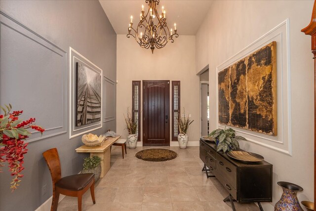 602 Pinnacle Dr W, Madera, CA 93636 - entryway with a chandelier, a towering ceiling, and light tile patterned floors