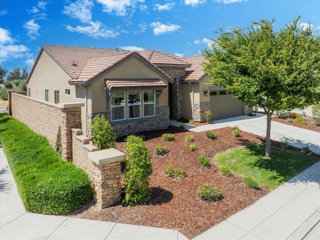 602 Pinnacle Dr W, Madera, CA 93636 - view of front of property featuring stone siding, stucco siding, a garage, and driveway