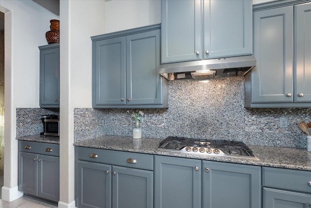602 Pinnacle Dr W, Madera, CA 93636 - kitchen featuring stainless steel gas stovetop, under cabinet range hood, decorative backsplash, and stone counters