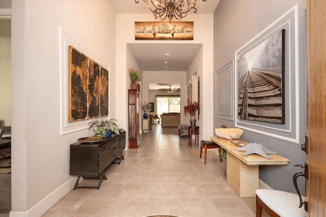 602 Pinnacle Dr W, Madera, CA 93636 - hallway with a chandelier and baseboards