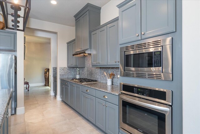 602 Pinnacle Dr W, Madera, CA 93636 - kitchen with stainless steel appliances, tasteful backsplash, light stone counters, and gray cabinets