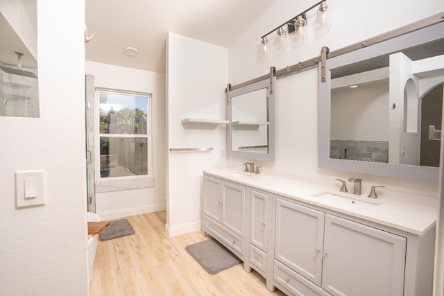 318 San Madele Ave, Coalinga, CA 93210 - full bath featuring double vanity, a shower, and wood finished floors