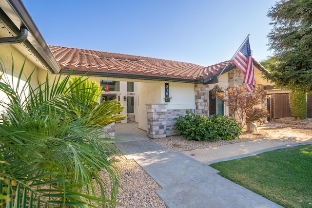 318 San Madele Ave, Coalinga, CA 93210 - view of front of home featuring stone siding, stucco siding, and a tiled roof