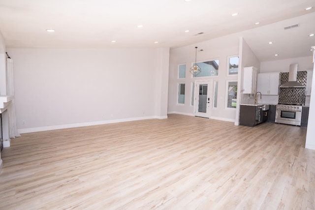 318 San Madele Ave, Coalinga, CA 93210 - unfurnished living room with a fireplace, light wood-style floors, and recessed lighting