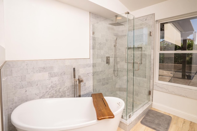 318 San Madele Ave, Coalinga, CA 93210 - full bath with a stall shower, a freestanding tub, and wood finished floors