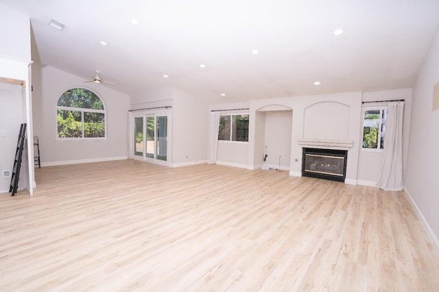 318 San Madele Ave, Coalinga, CA 93210 - unfurnished living room featuring a glass covered fireplace, ceiling fan, light wood-style flooring, recessed lighting, and lofted ceiling