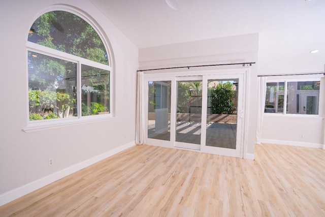 318 San Madele Ave, Coalinga, CA 93210 - empty room featuring wood finished floors and vaulted ceiling