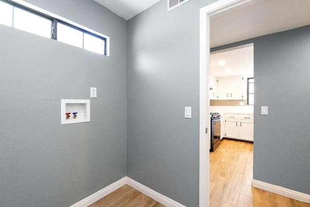 4727 E Alamos Unit 118, Fresno, CA 93726 - washroom with light wood finished floors and hookup for a washing machine