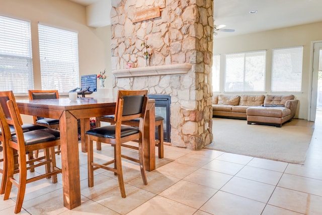 7951 N Fine Ave, Fresno, CA 93720 - tiled dining room featuring a ceiling fan and a fireplace